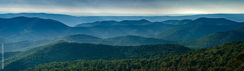 View of Blue Ridge Mountains (near) and Appalachian Mountains (distance) from overlook on Skyline Drive in Shenandoah National Park, Virginia, USA, in late September.